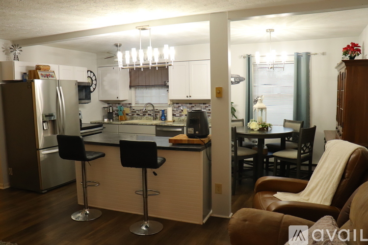 A kitchen with a bar area and a dining table.