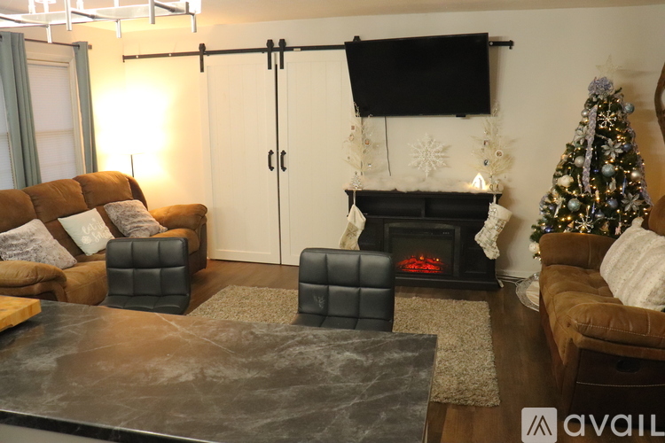 A living room with a fireplace, a couch, and a coffee table.