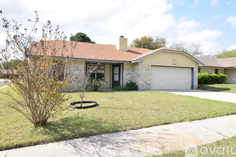 A house with a brown roof and a white garage door.