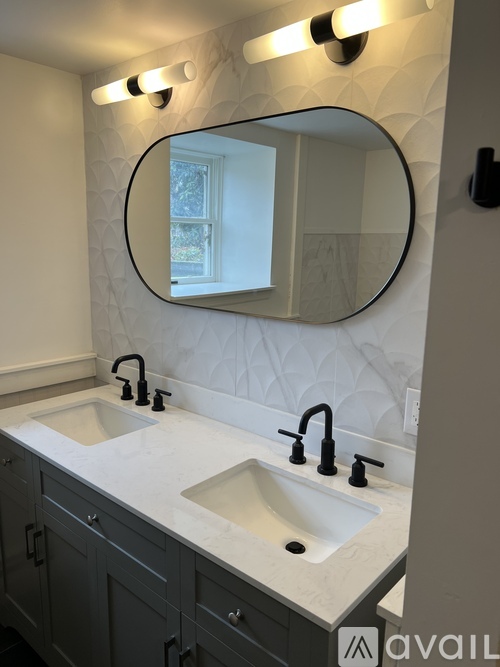 A bathroom with a sink and a mirror.