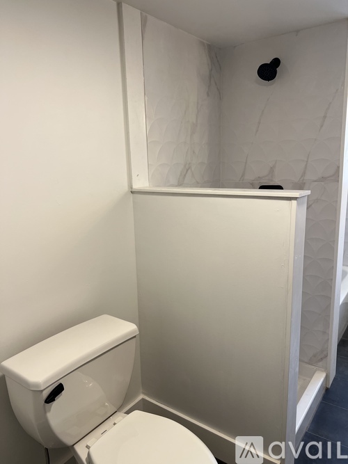 A white toilet with a white tank in a bathroom.