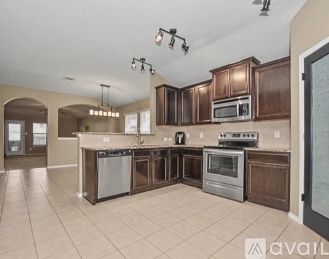 A kitchen with brown cabinets and a white countertop.