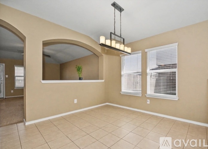 A room with beige walls and a tiled floor.