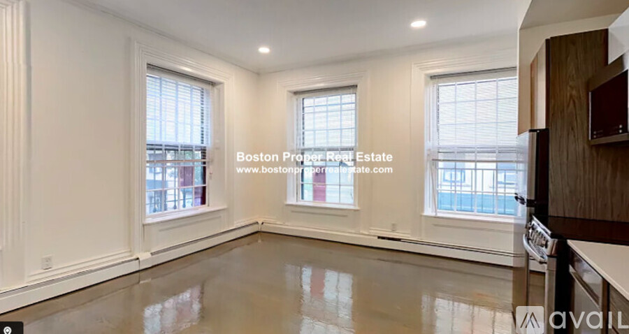A spacious room with a view of the city through the windows.