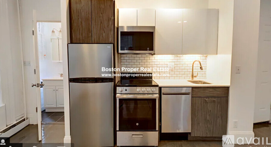 A kitchen with a stainless steel refrigerator, oven, and microwave.