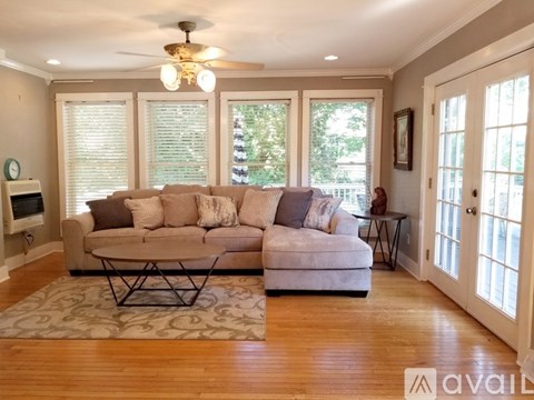 A living room with a large sectional sofa and a coffee table.