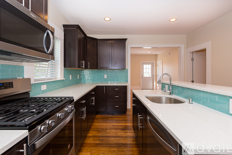 A kitchen with a stove top oven and a sink.