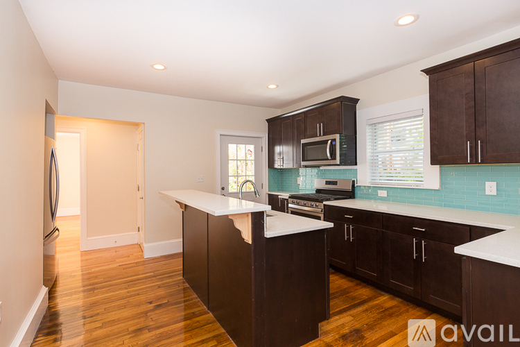 A kitchen with brown cabinets and a white counter top.