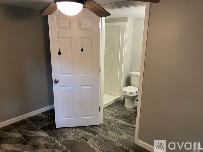 A bathroom with a toilet and a door.