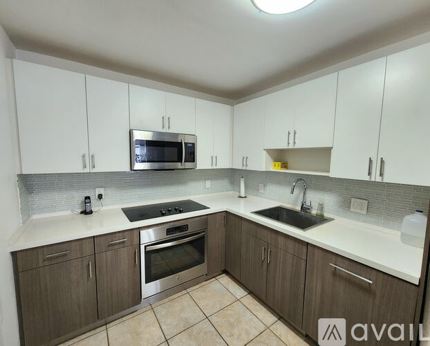 A kitchen with brown cabinets and a white countertop.