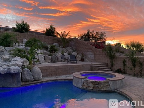 A pool with a hot tub in the middle of it.