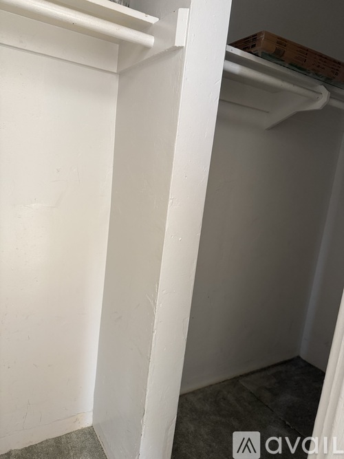 A white refrigerator with a box on top of it.
