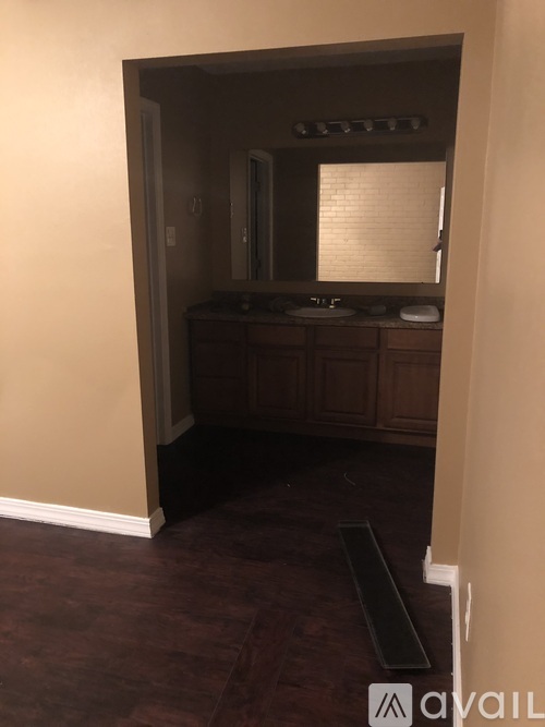 A bathroom with a vanity and a mirror.