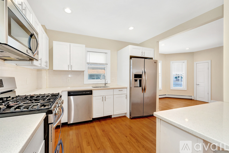A kitchen with a stove top oven and a refrigerator.