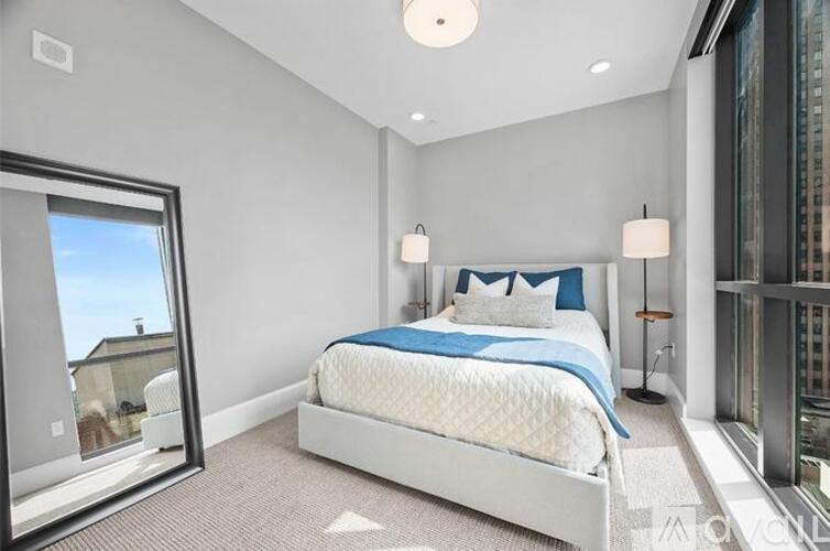 A bedroom with a large bed and a view of the city.