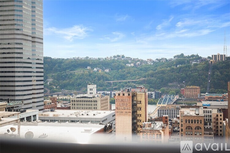 A cityscape with a mix of modern and older buildings, with a clear sky above.