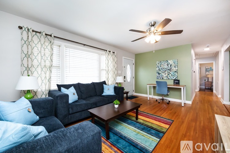 A living room with a dark blue couch and a wooden coffee table.