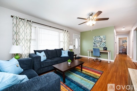 A living room with a dark blue couch and a wooden coffee table.