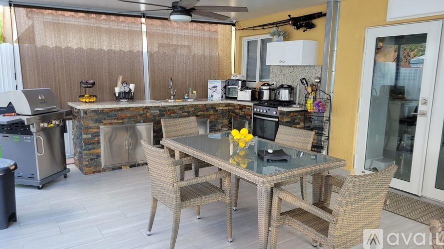 A kitchen with a glass table and chairs.