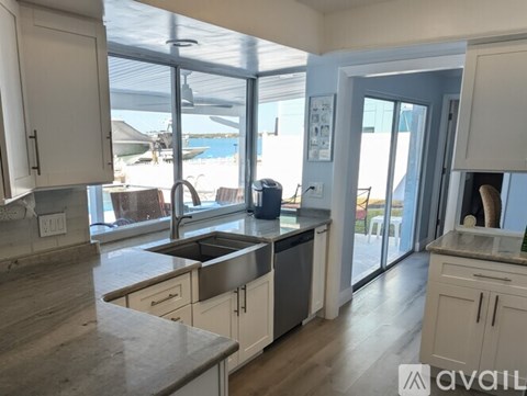 A kitchen with a sink and a window overlooking the outside.