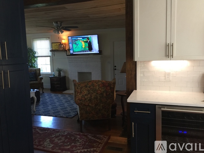 A living room with a television and a fireplace.