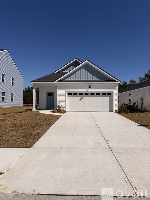 A two-story house with a garage is situated in a residential area.