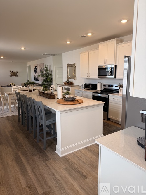 A modern kitchen with a dining table and chairs.