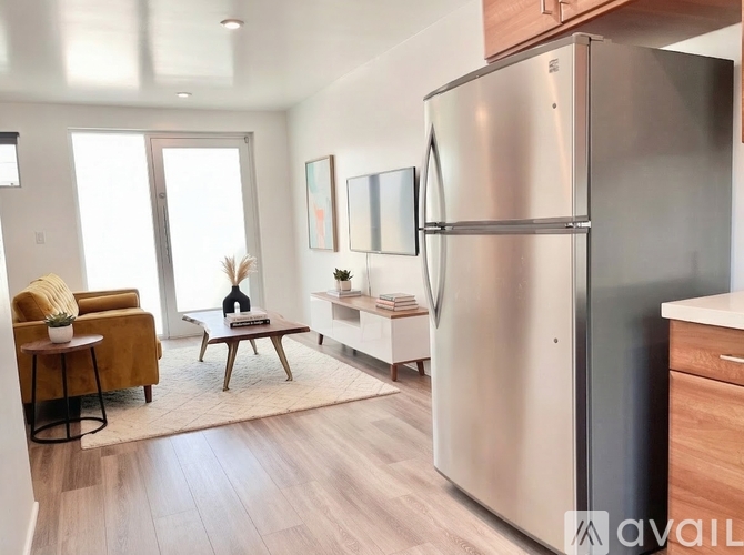 A modern kitchen with a refrigerator on the right side.
