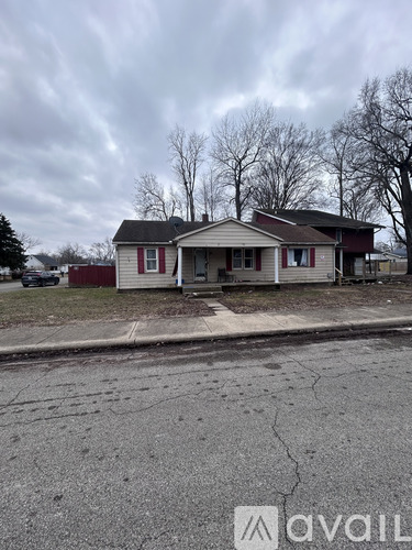 A house with a cracked driveway in front of it.