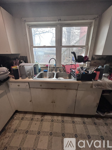A kitchen with a sink and a window.