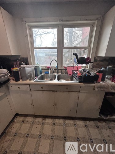 A kitchen with a sink and a window.