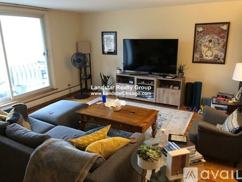 A living room with a couch, coffee table, and television.