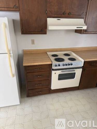 A white fridge and a white oven in a kitchen.
