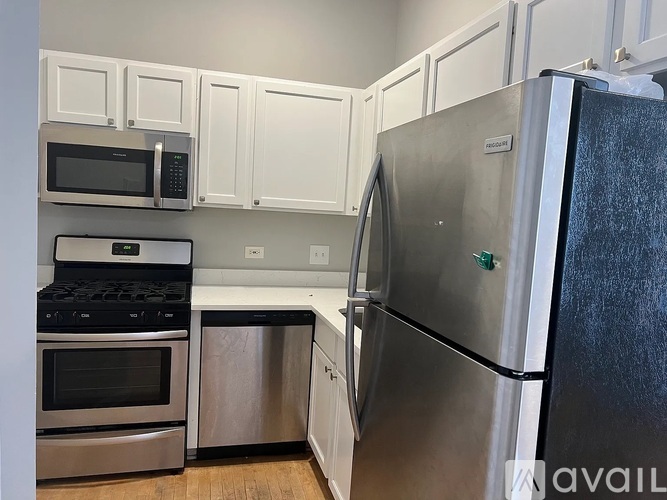 A kitchen with a stainless steel refrigerator, oven, and microwave.