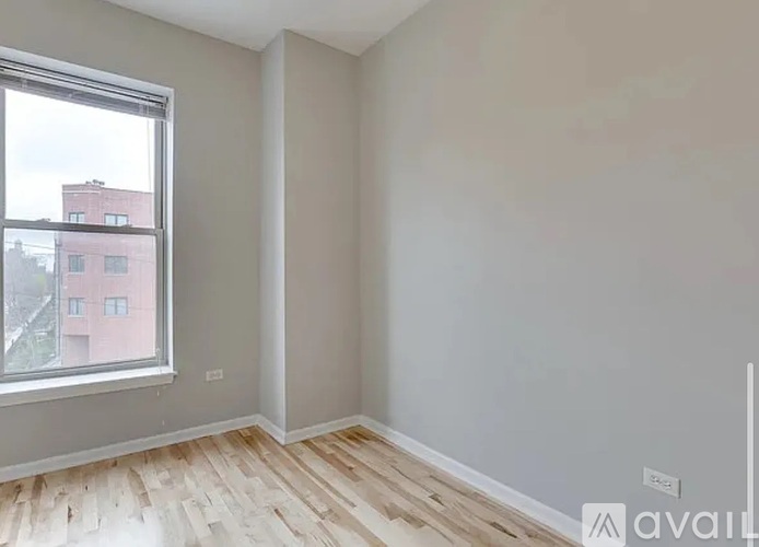 A room with a window and wooden flooring is available for rent.
