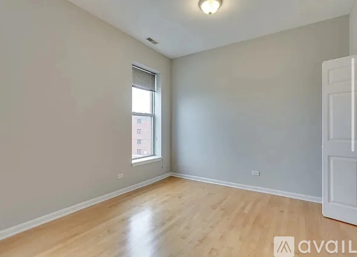 Empty room with wooden floor and white walls.