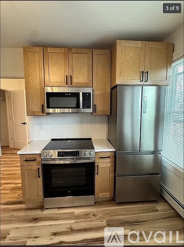 A kitchen with wooden cabinets and stainless steel appliances.