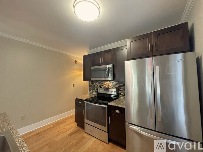 A kitchen with a stainless steel refrigerator and microwave.