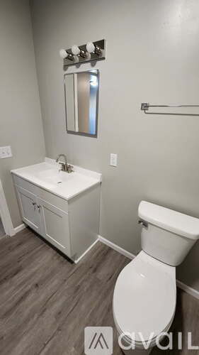 A white toilet sits next to a sink in a bathroom.