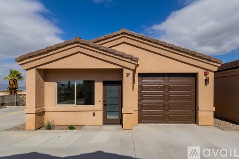A house with a brown garage door and a glass door.