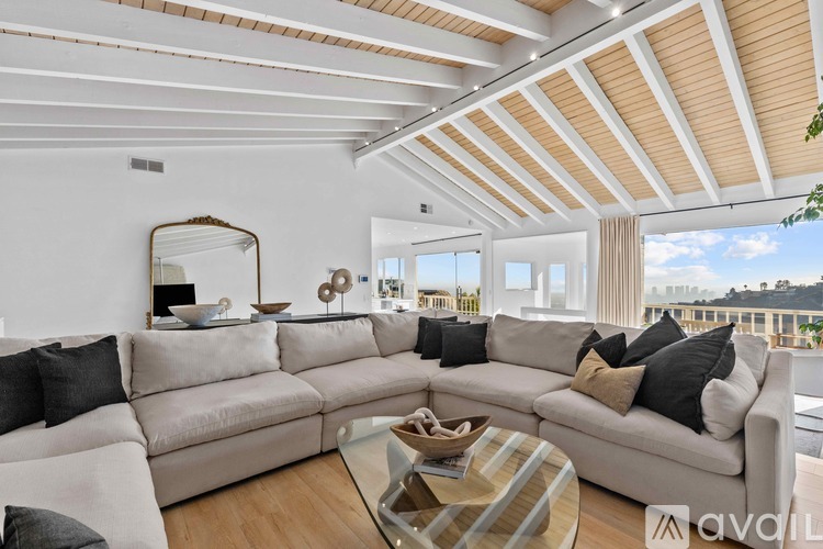 A living room with a large sectional sofa and a coffee table.