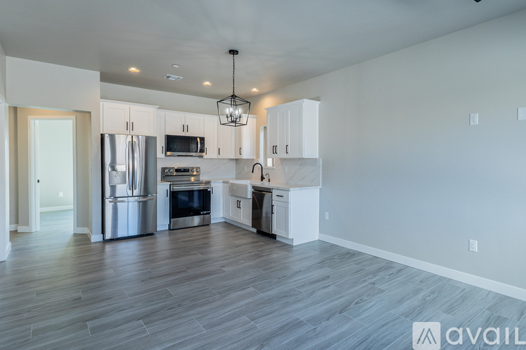 A modern kitchen with stainless steel appliances and white cabinets.