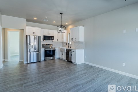 A modern kitchen with stainless steel appliances and white cabinets.
