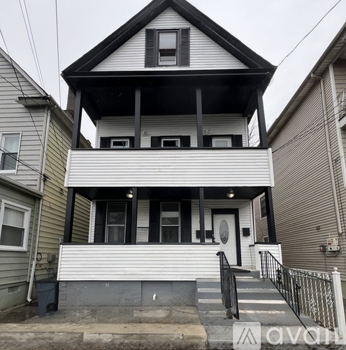 A two-story house with a white front and black trim.