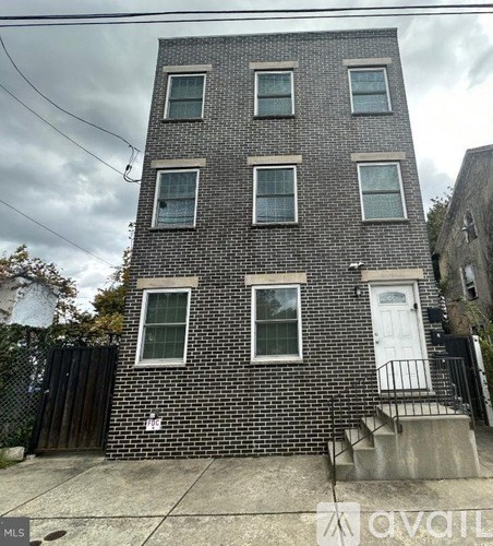 A brick building with a white door and windows.