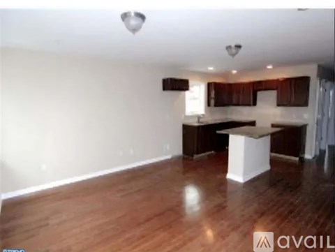 A room with wooden floors and a white counter.