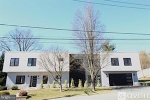 A modern two-story house with a garage is for sale.