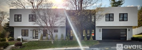 A modern two-story house with a garage is for sale.