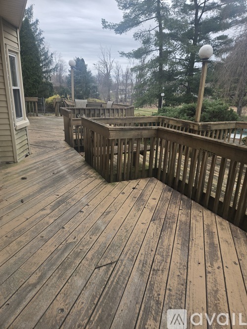 A wooden deck with a railing and a lamp post.