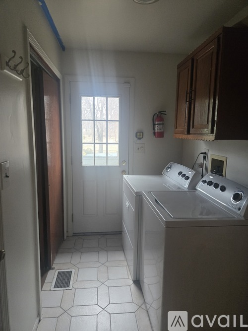 A kitchen with a stove top oven and a refrigerator.